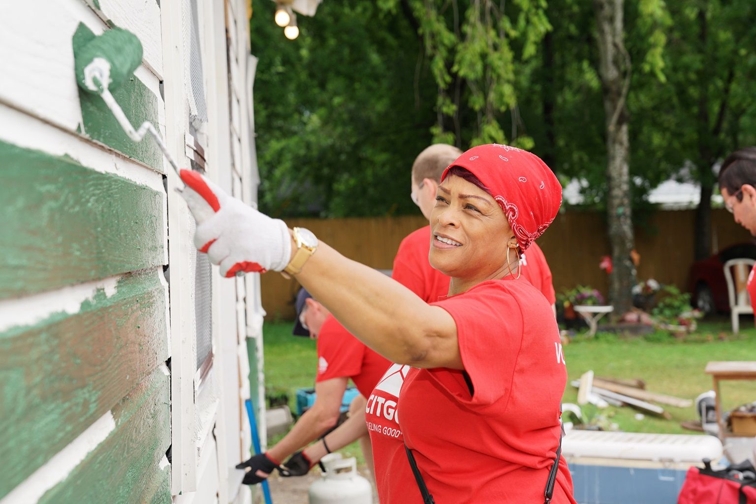 Citgo employee helping paint at a community event