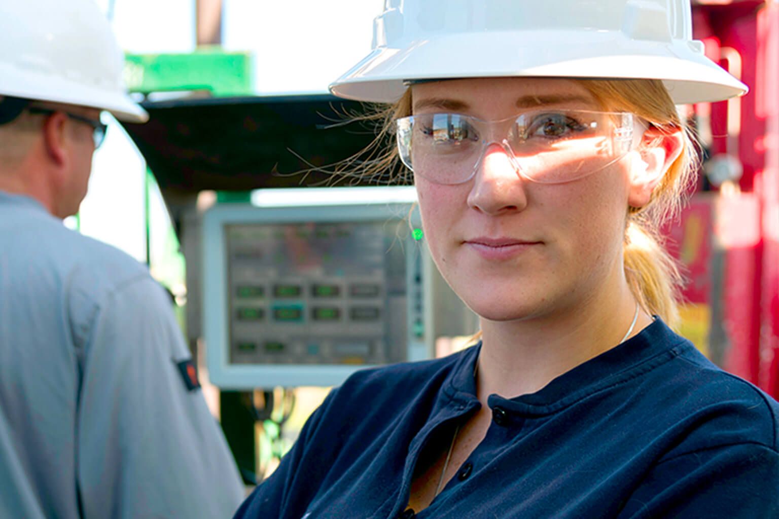 Person wearing hard hat and safety glasses
