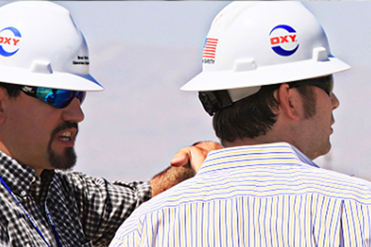 Two people wearing hardhats