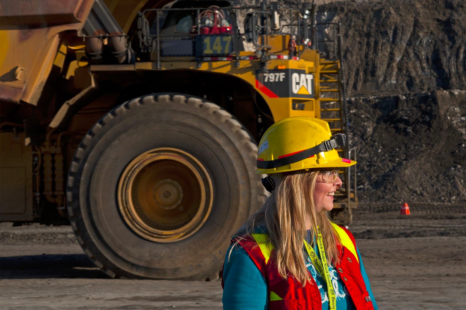 Person wearing safety gear standing in front of machinery