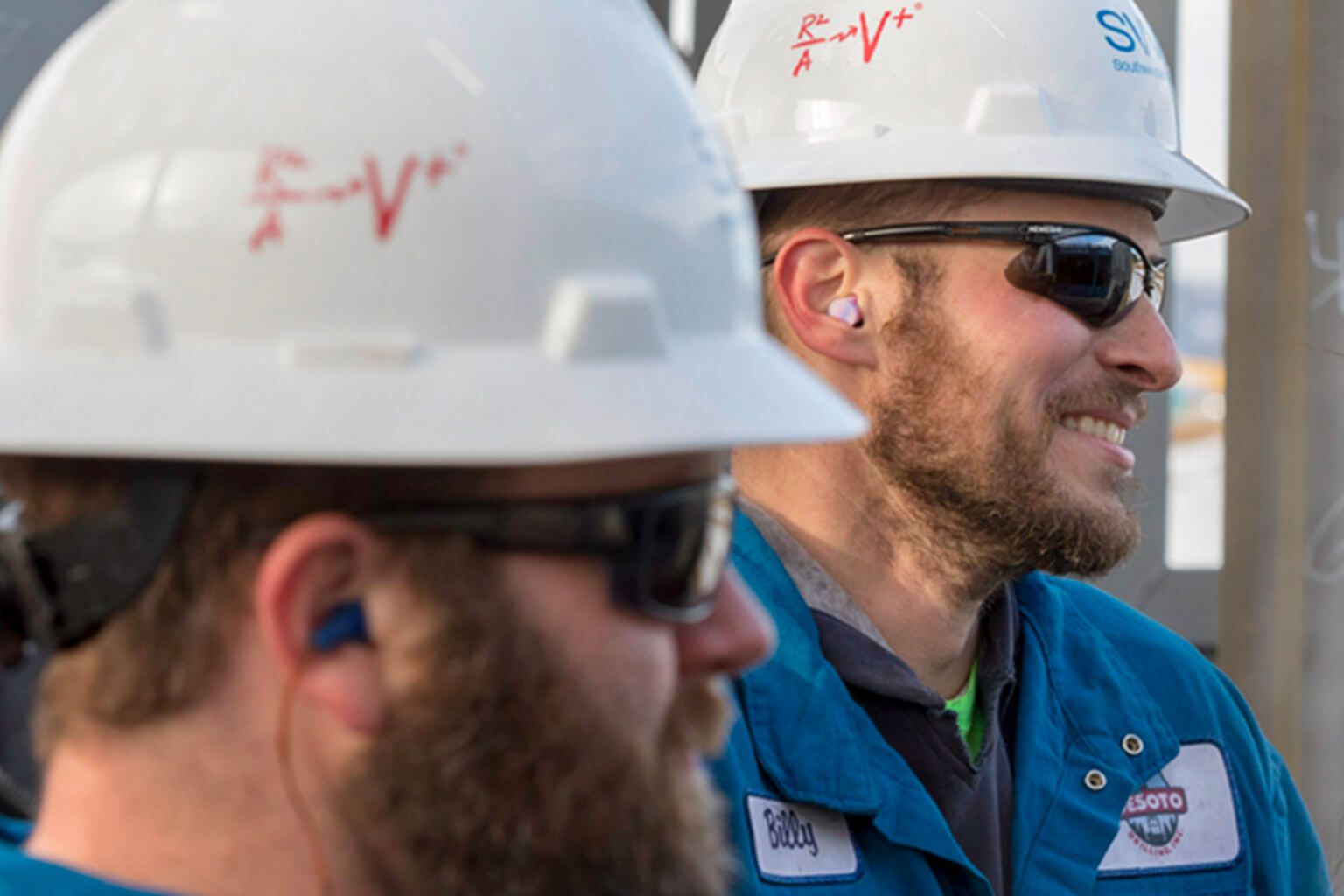 Two people wearing hard hats