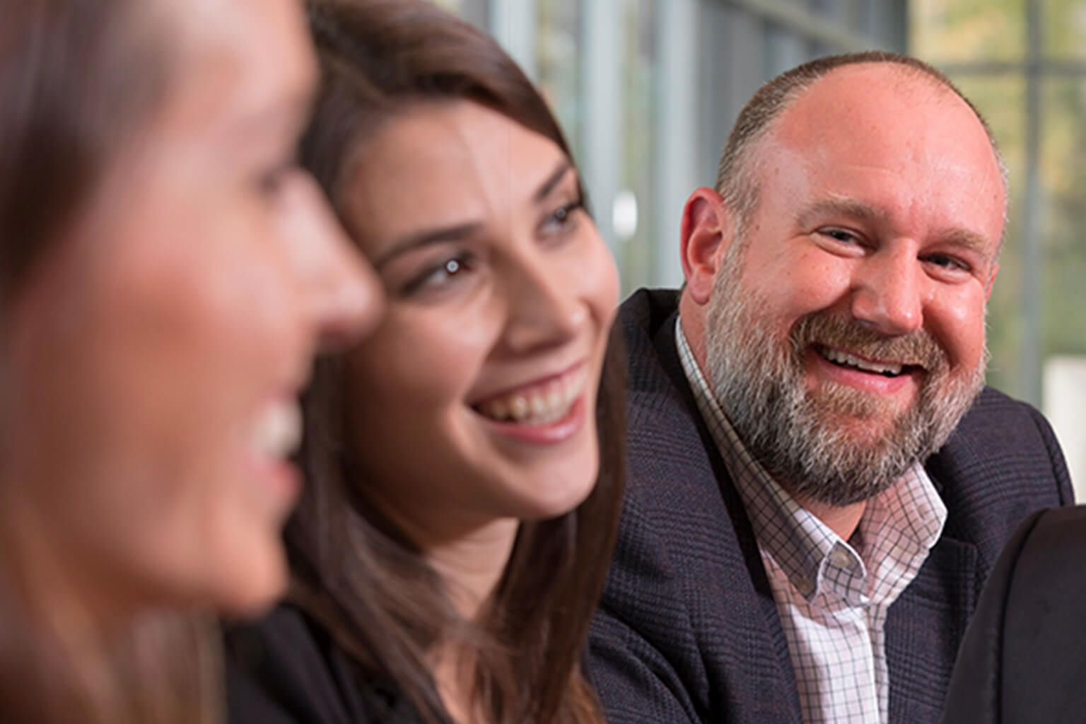 Three people smiling