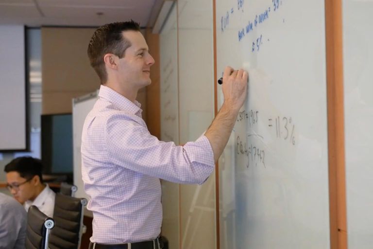 Person writing on whiteboard