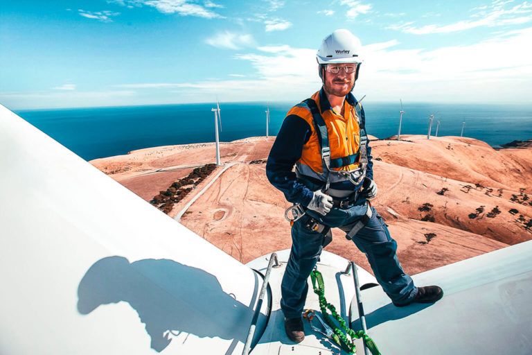 Person standing on wind turbine