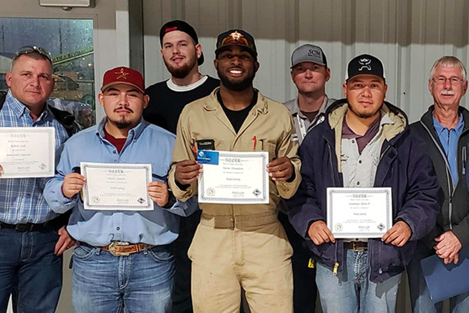 Group holding up certificates